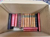a cardboard box filled with books on a table