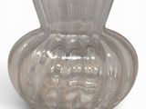 a clear glass vase that is sitting on a white surface