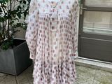 dress on a mannequin stand in front of a door