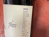 a bottle of wine sitting on a table next to a bottle of wine