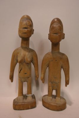 pair of wooden figurines of a man and a woman