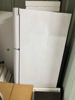 a refrigerator and a freezer in a small room