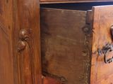 a wooden cabinet with a drawer on top of it