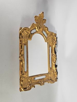 un miroir doré accroché au mur d'une pièce