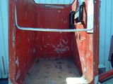 a rusted out toilet in the back of a truck