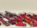 a lot of toy fire trucks that are sitting on a table