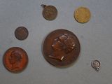 a lot of coins and a penny on the table