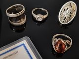 many rings that are sitting on a black table