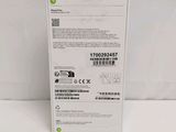 the back of a white box with a green sticker on it