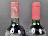 two bottles of wine that are sitting on a table