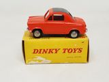 a red toy car sitting on top of a yellow box