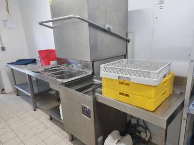une cuisine équipée d'un évier et d'un plan de travail sur lequel sont posés des paniers