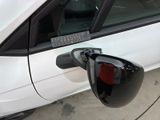 a close up of a car ' s side mirror and door handle