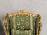 a green and gold chair with a gold trim