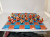 a lot of figurines that are sitting on a chess board