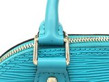 a close up of a blue handbag on a white background