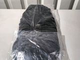 a bag of clothes wrapped in plastic sitting on a table
