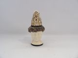 a figurine of a man with a hat on it ' s head