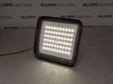 a close up of a flood light on a table in front of a wall