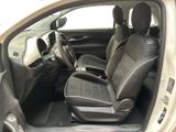 the interior of a small car with two black seats and a steering wheel