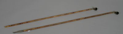 a pair of wooden sticks that are next to each other