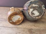 a brown and white vase and a brown and white cup on a wooden table