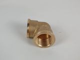 a close up of a brass pipe on a white surface