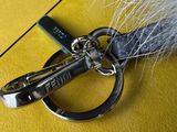 a close up of a keychain with a fur on it