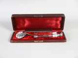 a silverware in a red case on a white surface
