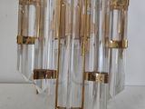 a glass and brass chandelier hanging from the ceiling