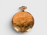 a gold pocket watch with a picture of a horse on it