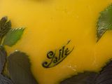 a yellow vase with leaves on it with the word sale written on it