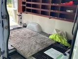a bed in the back of a van with a mattress on it