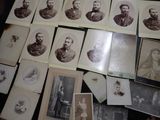 many old photographs of men and women on the table