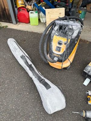 un aspirateur jaune et noir ainsi que d'autres outils posés par terre