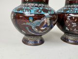 two vases that are sitting on a table