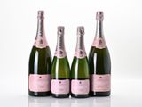 three bottles of champagne sitting next to each other on a table