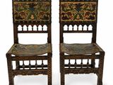 pair of carved chairs with floral designs on the backs