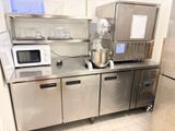 a kitchen with stainless steel cabinets and a mixer on the counter