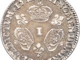 a silver coin with a crown on top of it