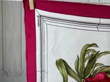 towels hanging on a clothes line in a room with a wallpapered wall