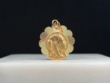 un gros plan d'une médaille d'or posée sur un socle blanc