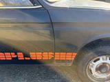 a black car with orange lettering on the side of it