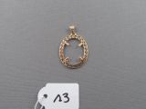 a close up of a gold necklace with a tag on it