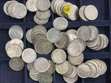 a lot of silver coins in a blue tray