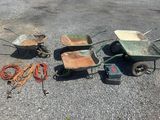 three wheelbarrows, a wheelbarrow, a wheelbarrow, and a wheelbarrow on the ground