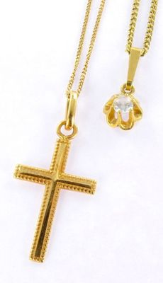 a gold cross necklace and a gold flower pendant on a white background