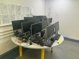 many computers on the table in the room