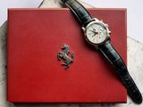 a watch sitting on top of a red box on a table