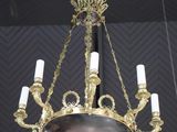 an antique brass chandelier hanging from a ceiling with candles
